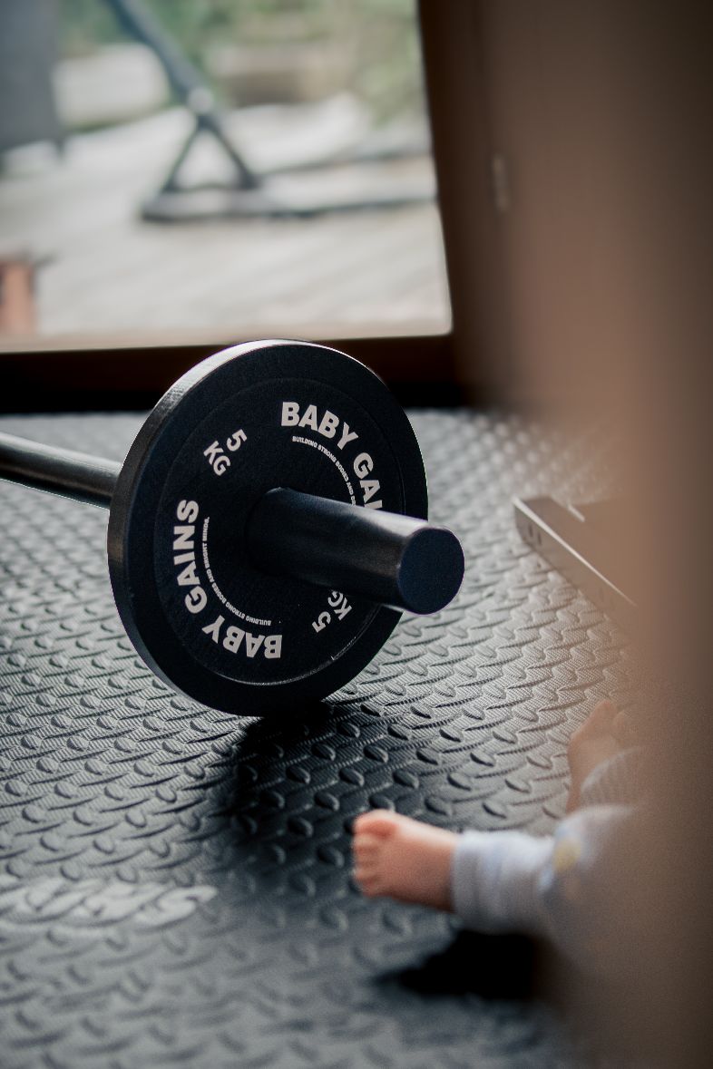 Kid mid-clean with the BabyGains barbell