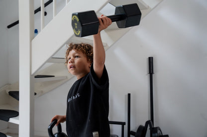 Child training with the Baby Gains wooden dumbbell set