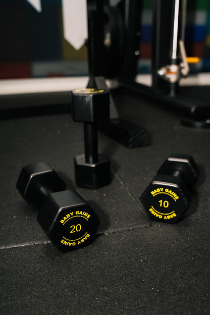 Baby Gains kids dumbbells 20 and 10 on a gym floor
