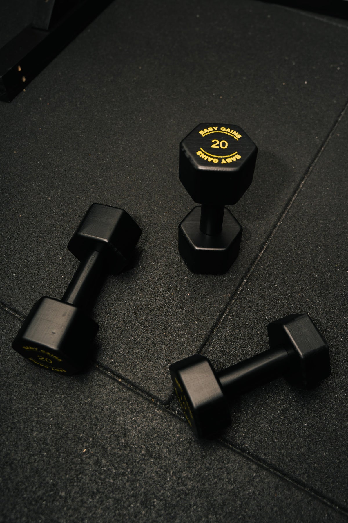 Baby Gains kids hex dumbbells lying and standing on a gym floor
