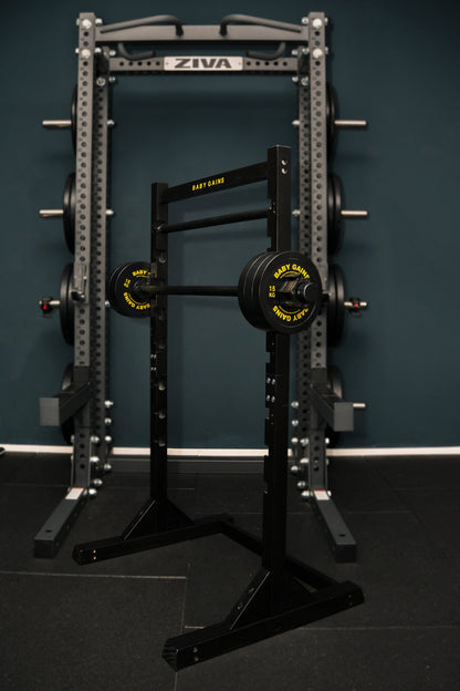 Kids Squat, Bench & Pull-Up Station standing inside an adult power rack, showing its size